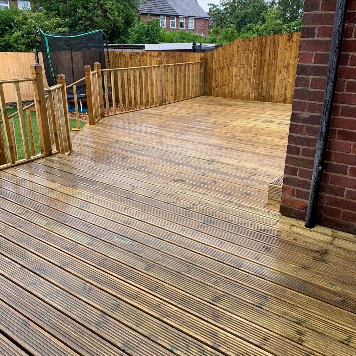 Timber deck with handrail and garden fence