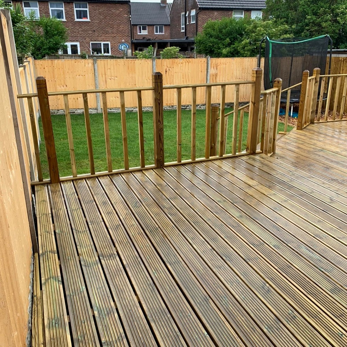 Timber deck looking onto a lawn and new fence