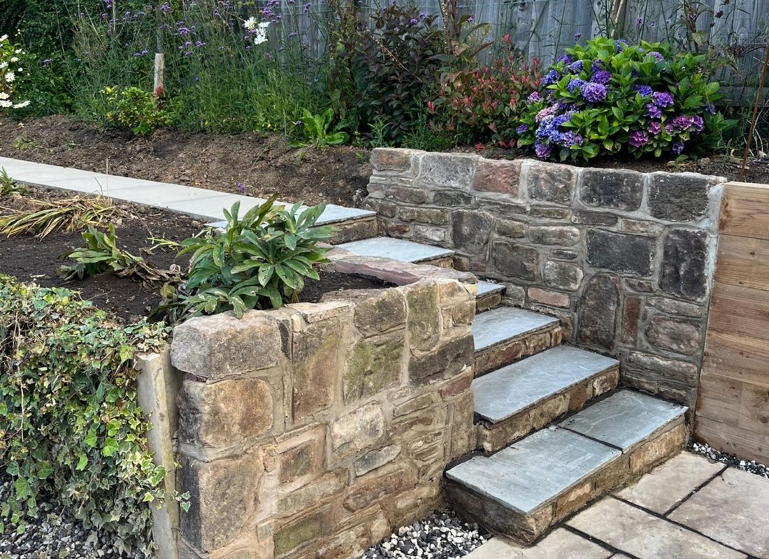 Stone retaining wall and flagged garden steps